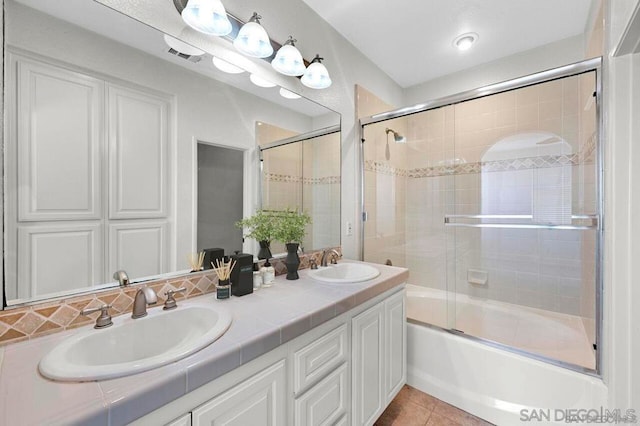 bathroom with vanity, tile patterned floors, and enclosed tub / shower combo