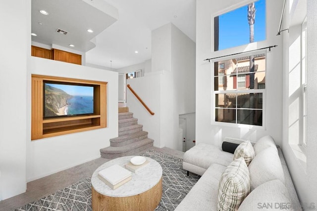 living room with a towering ceiling