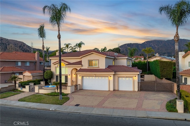 mediterranean / spanish-style house featuring a garage and a mountain view