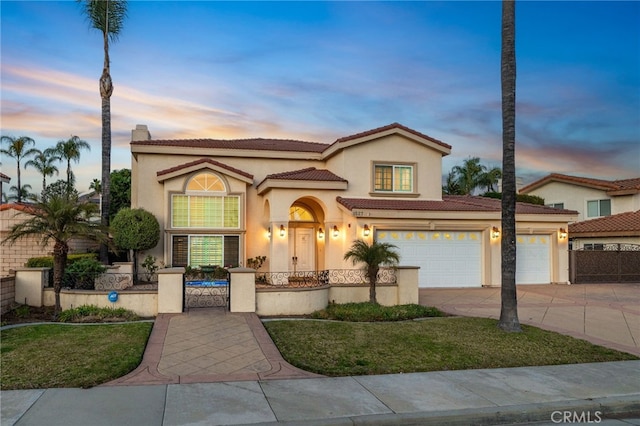 mediterranean / spanish-style house with a garage