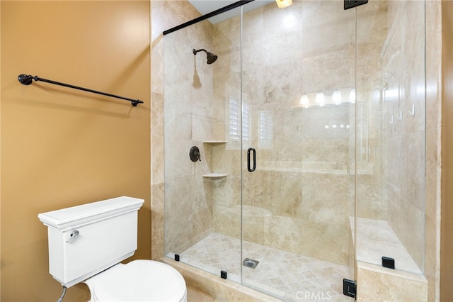 bathroom featuring walk in shower and toilet