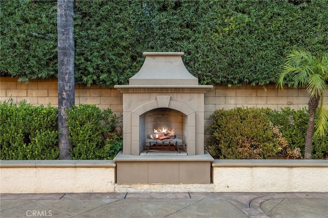 exterior space with an outdoor fireplace