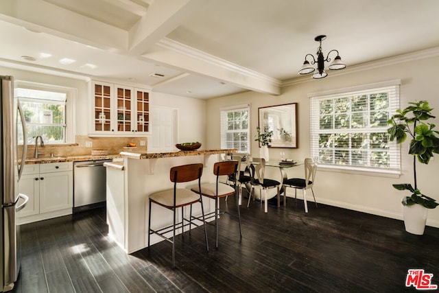 kitchen with tasteful backsplash, white cabinetry, hanging light fixtures, stainless steel appliances, and beam ceiling