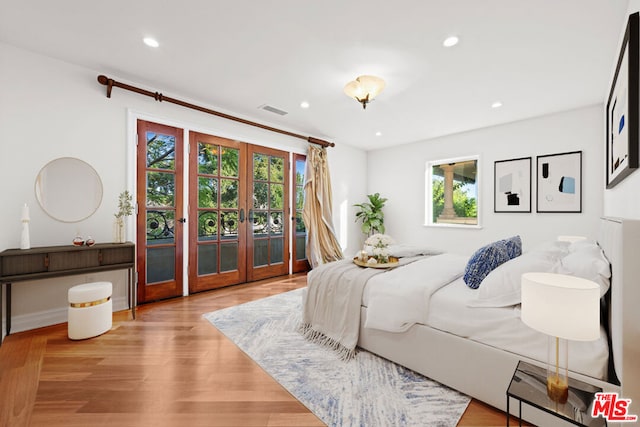 bedroom with french doors, light hardwood / wood-style flooring, and access to outside