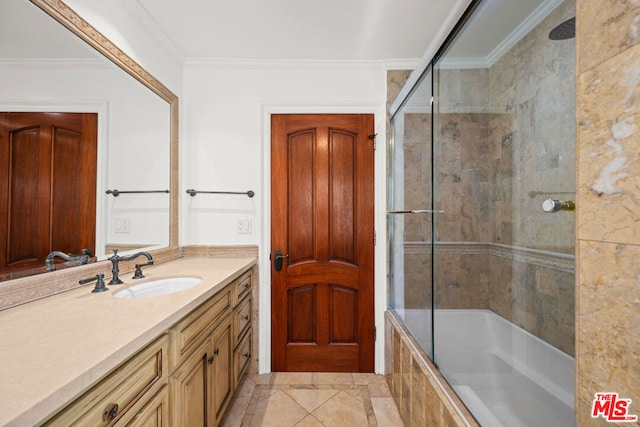 bathroom featuring tile patterned flooring, enclosed tub / shower combo, ornamental molding, and vanity