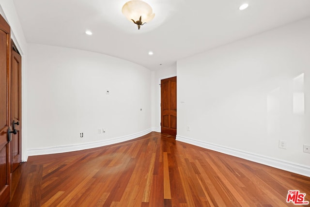 unfurnished bedroom with wood-type flooring and a closet