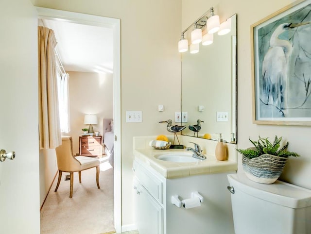 bathroom featuring vanity and toilet