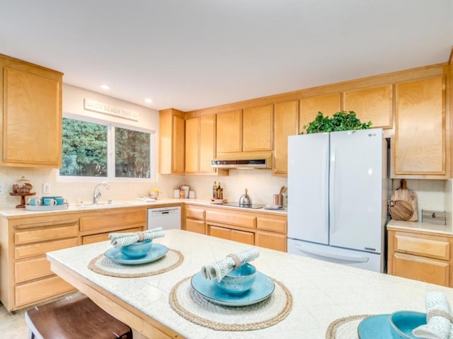 kitchen featuring light brown cabinetry, sink, and white appliances