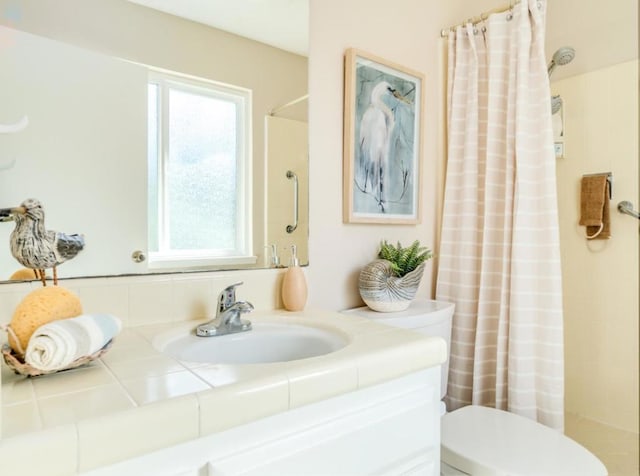 bathroom with vanity, a shower with curtain, and plenty of natural light