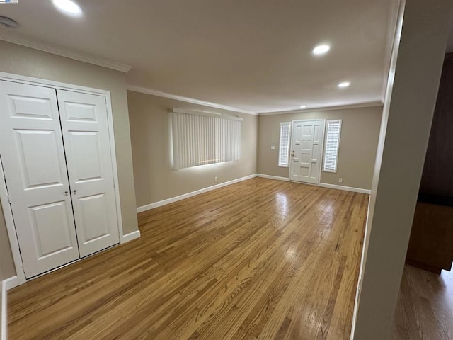 interior space featuring crown molding and hardwood / wood-style flooring