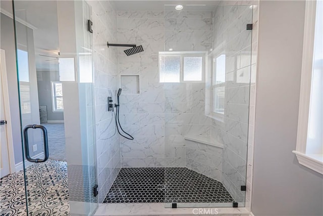 bathroom with an enclosed shower and tile patterned floors