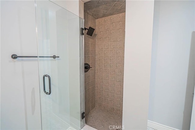 bathroom featuring a shower with door