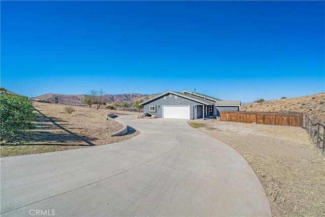 view of front facade with a garage and a mountain view