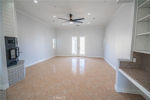 unfurnished living room with french doors, ceiling fan, ornamental molding, and light tile patterned floors