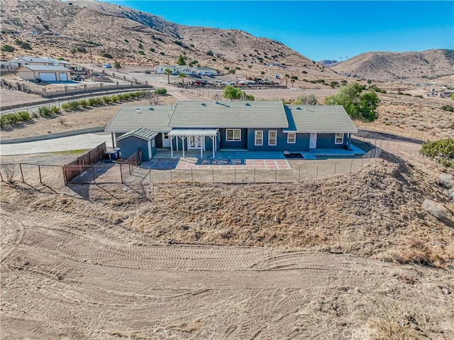 rear view of property with a mountain view and a patio