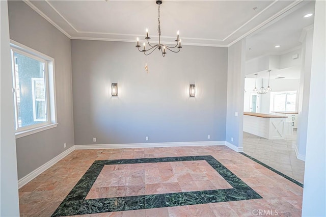 spare room with crown molding and a chandelier