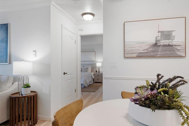 interior space featuring crown molding and light hardwood / wood-style floors