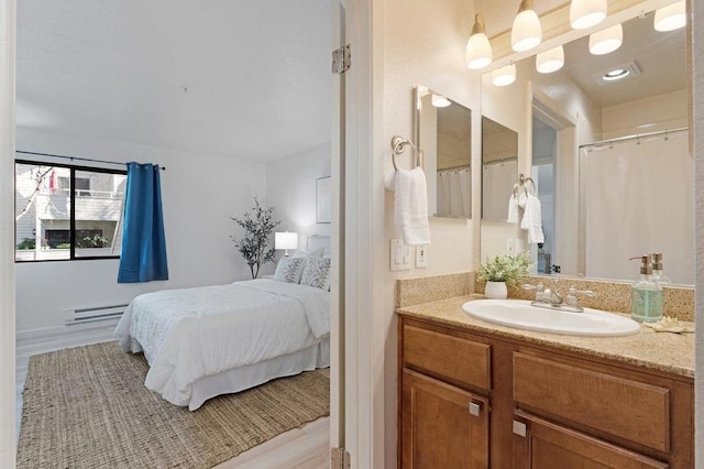 bathroom featuring a baseboard radiator and vanity