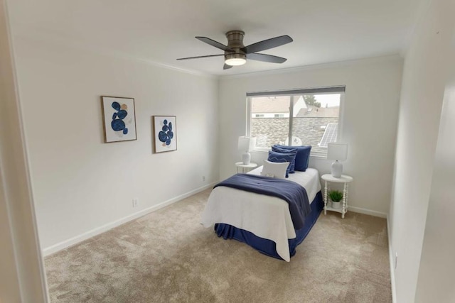 carpeted bedroom featuring ornamental molding and ceiling fan