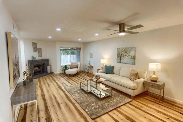 living room with light hardwood / wood-style floors and ceiling fan