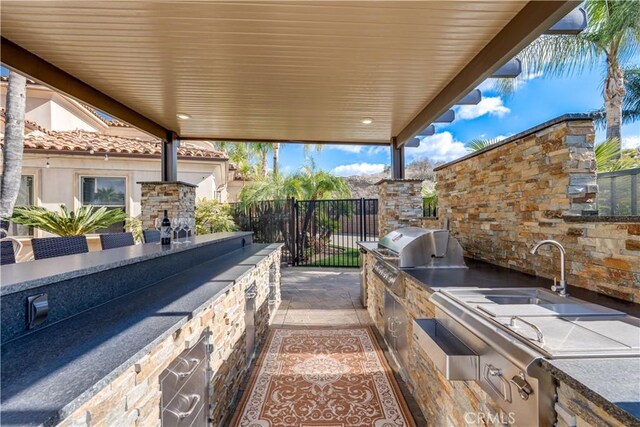 view of patio with exterior kitchen and grilling area