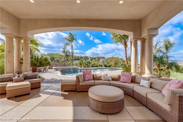 view of patio / terrace with a swimming pool with hot tub and outdoor lounge area