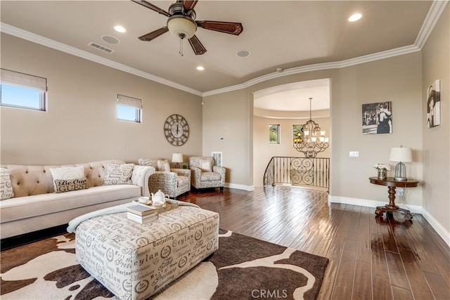 living room featuring dark wood-type flooring, crown molding, and ceiling fan with notable chandelier