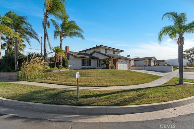 view of front of property with a garage and a front lawn