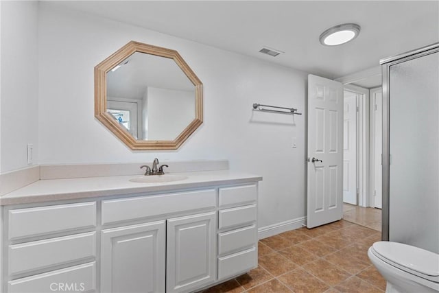 bathroom featuring vanity, tile patterned floors, and toilet