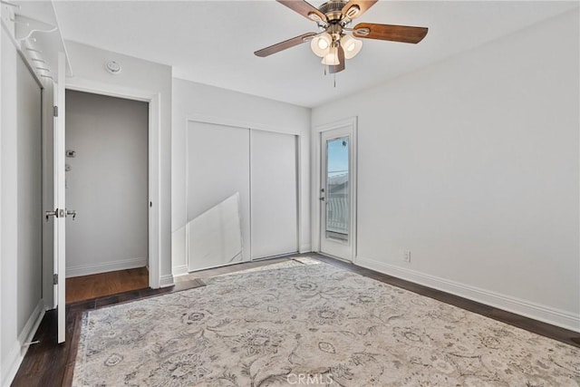 unfurnished bedroom with dark wood-type flooring and ceiling fan