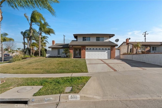 view of front of house with a garage and a front lawn