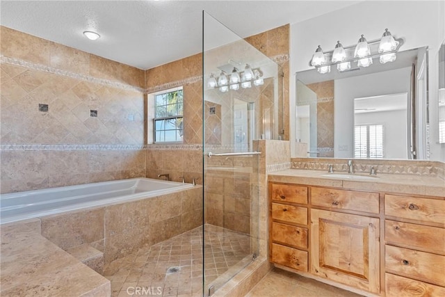 bathroom with tile patterned flooring, vanity, and separate shower and tub