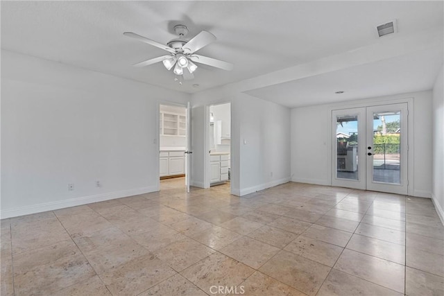 spare room with ceiling fan and french doors