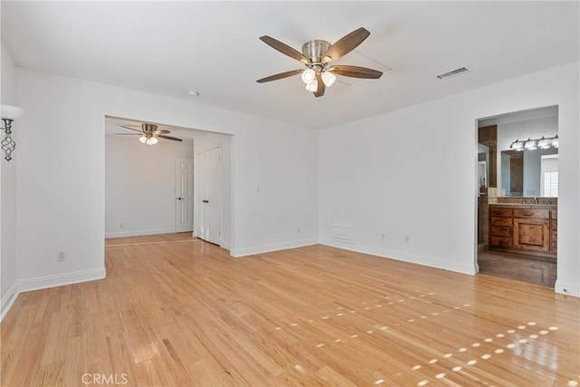 unfurnished room featuring ceiling fan and light hardwood / wood-style flooring