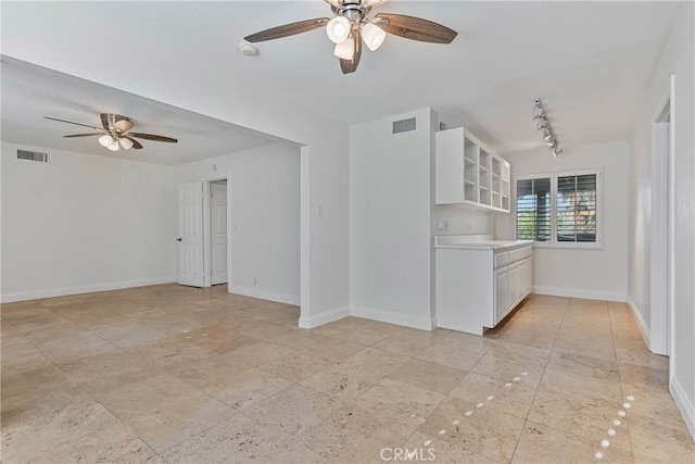 unfurnished living room with ceiling fan