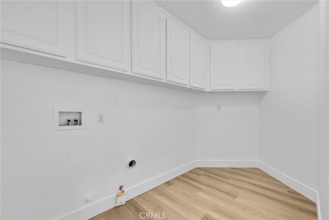 laundry room with cabinets, gas dryer hookup, hookup for a washing machine, and light wood-type flooring