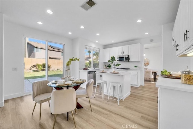 dining area featuring sink and light hardwood / wood-style floors