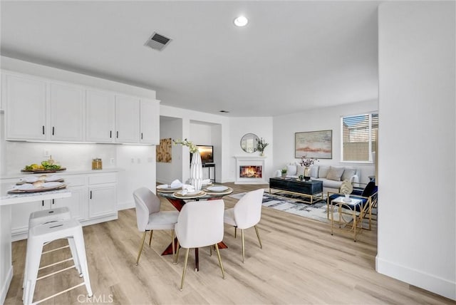 dining space featuring light wood-type flooring