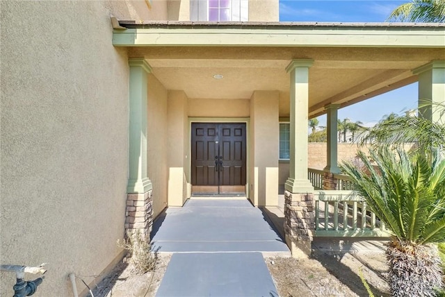 view of exterior entry featuring a porch