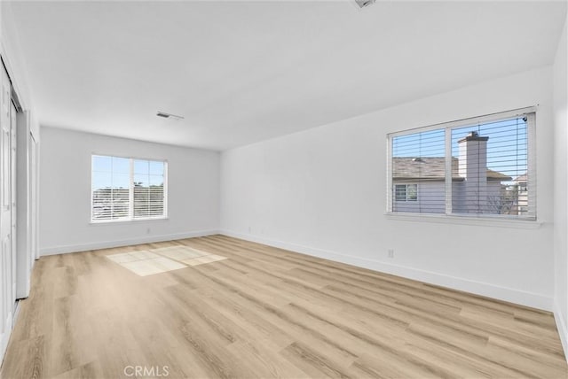 unfurnished room with light wood-type flooring