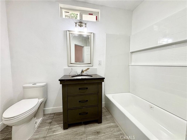 bathroom with toilet, wood finished floors, bathing tub / shower combination, vanity, and baseboards