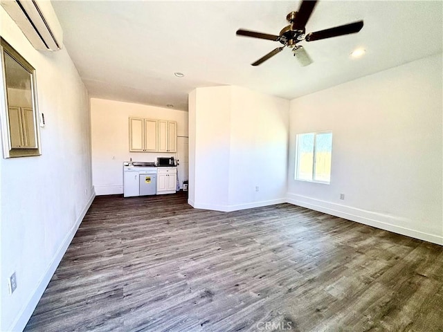 unfurnished living room with an AC wall unit, dark wood-type flooring, and baseboards