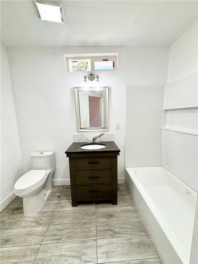 full bath featuring vanity, toilet, and baseboards