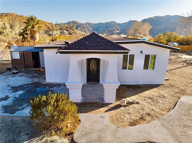 view of front of property with a mountain view and stucco siding