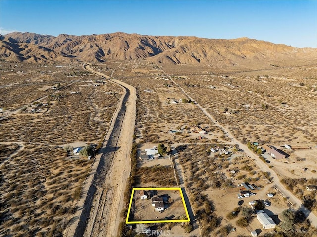 birds eye view of property featuring a desert view and a mountain view