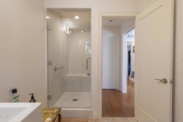 bathroom with vanity, hardwood / wood-style floors, and walk in shower