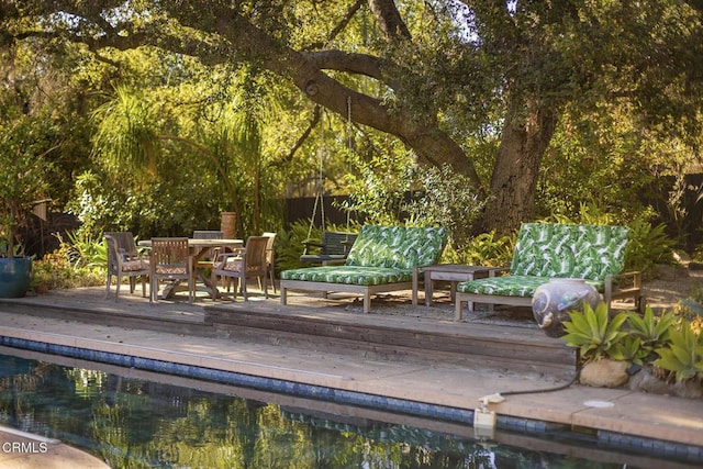 view of pool with a wooden deck