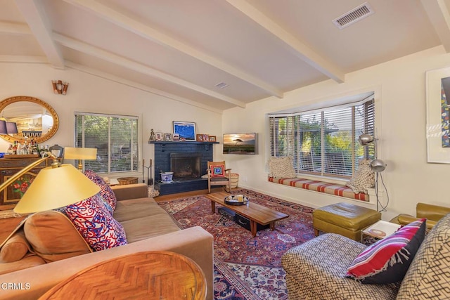 living room with vaulted ceiling with beams