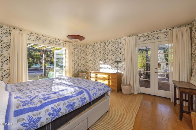 bedroom with french doors, access to exterior, and hardwood / wood-style flooring