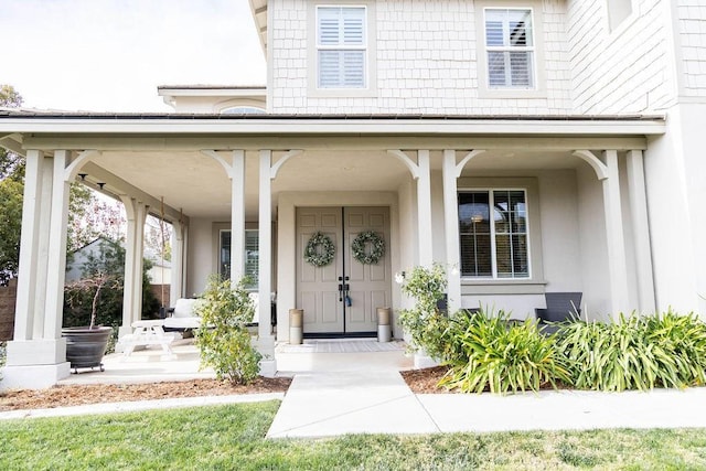 entrance to property featuring covered porch